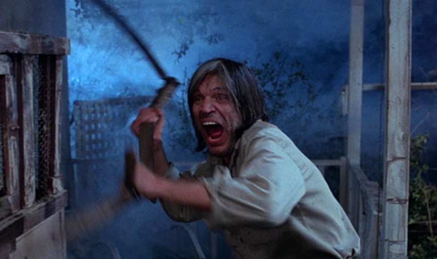 Neville Brand handles a scythe in Tobe Hooper's Eaten Alive